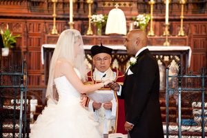 Bride and groom exchanging vows at St Michael and All Angels Church, Essex